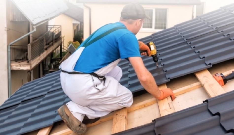 Roofer installing new asphalt shingles on a home